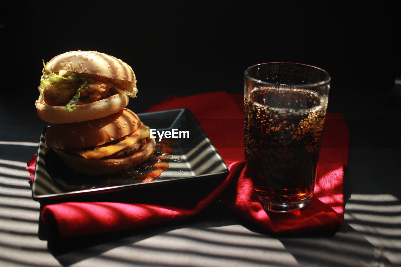 Close-up of drink served on table against black background