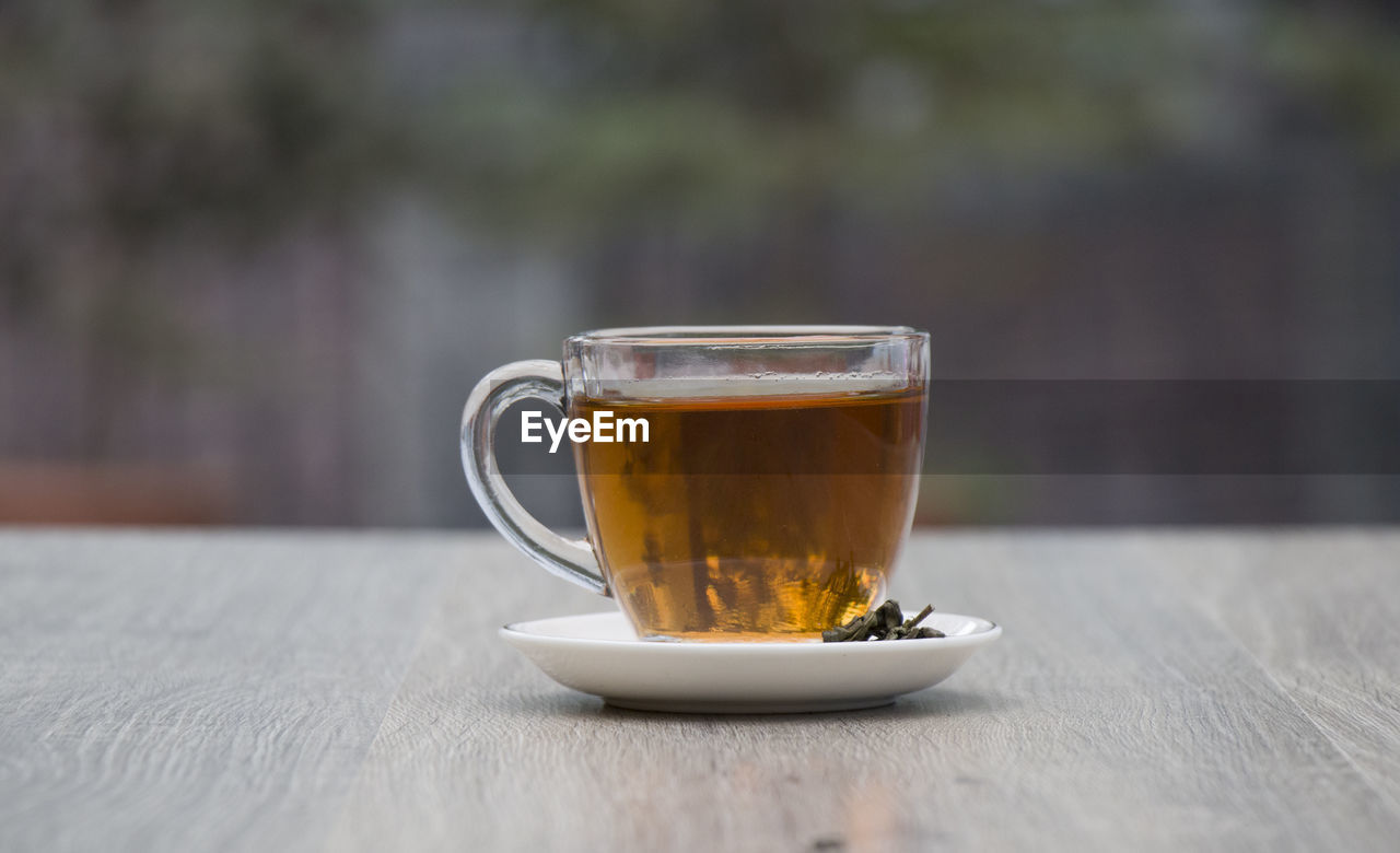 COFFEE CUP ON TABLE IN GLASS