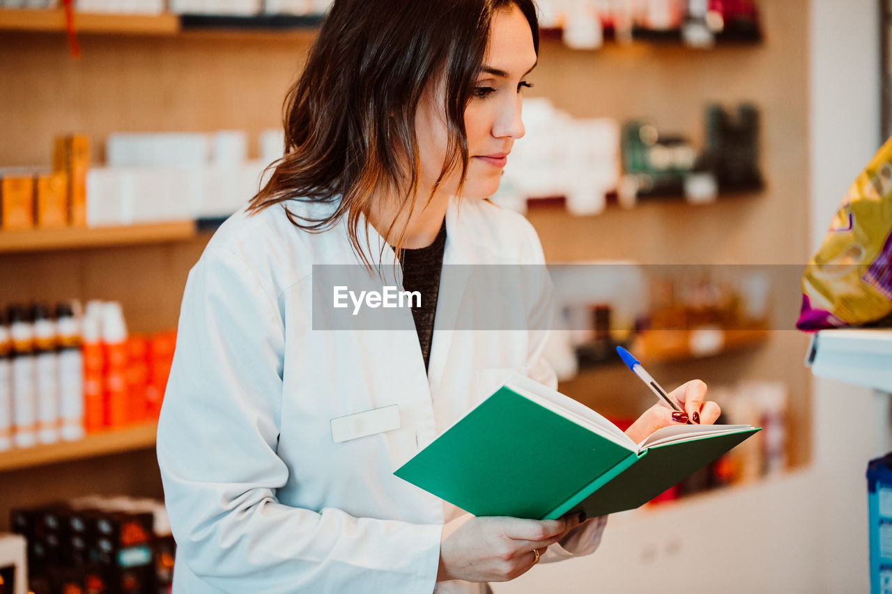 Female pharmacist working at store