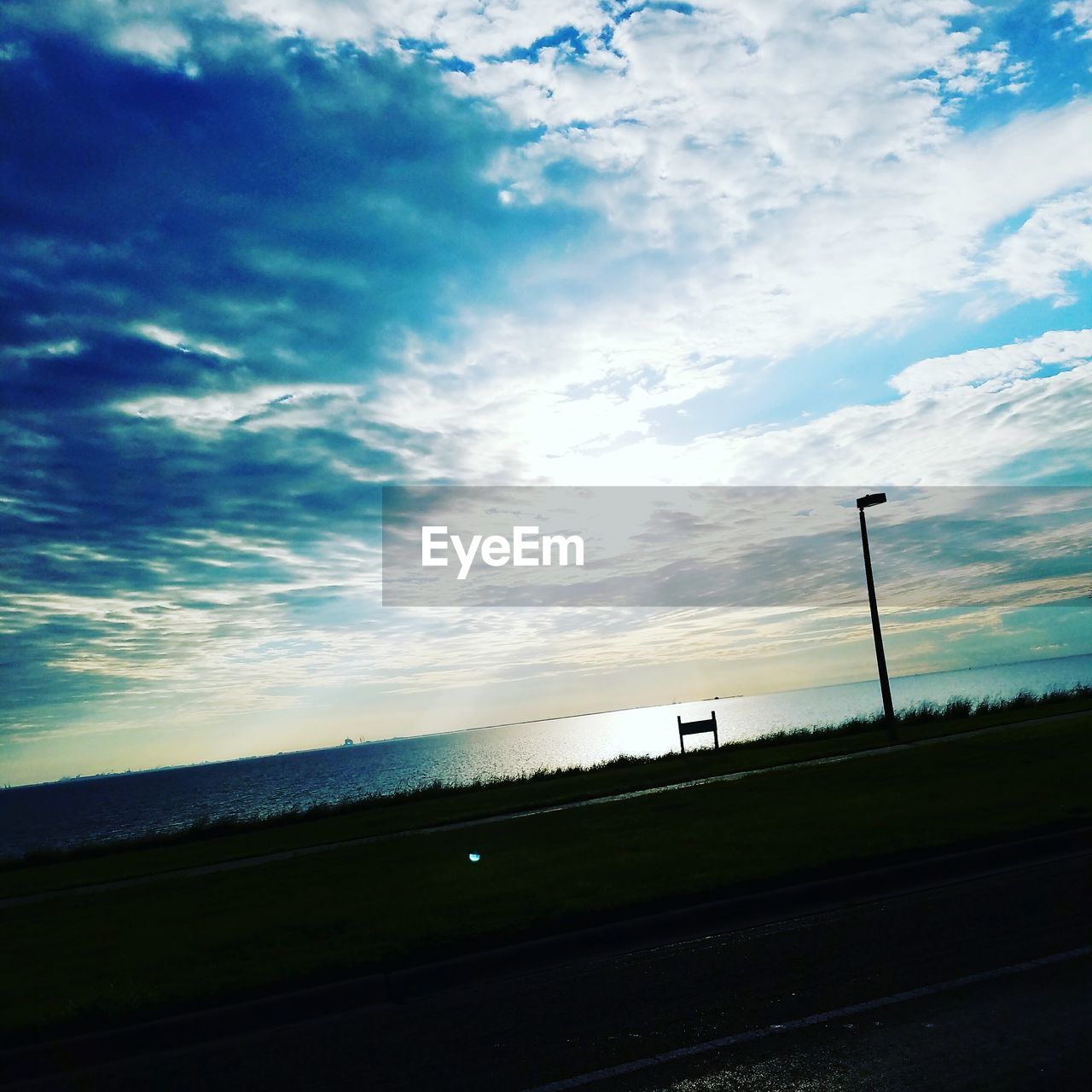 VIEW OF ROAD AGAINST CLOUDY SKY