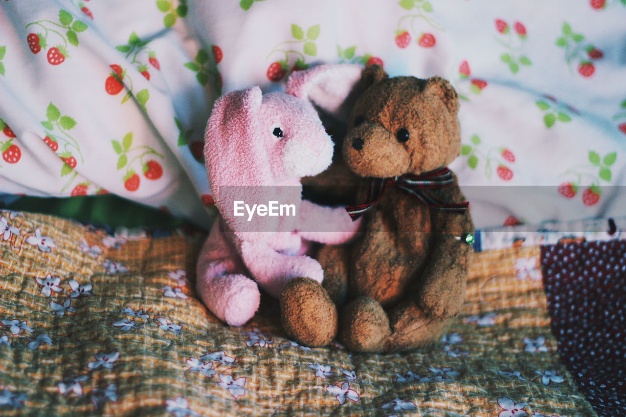 Close-up of stuffed toys on bed