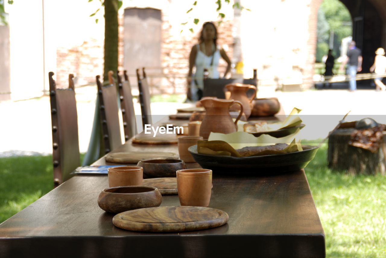 Food on table with woman standing in background