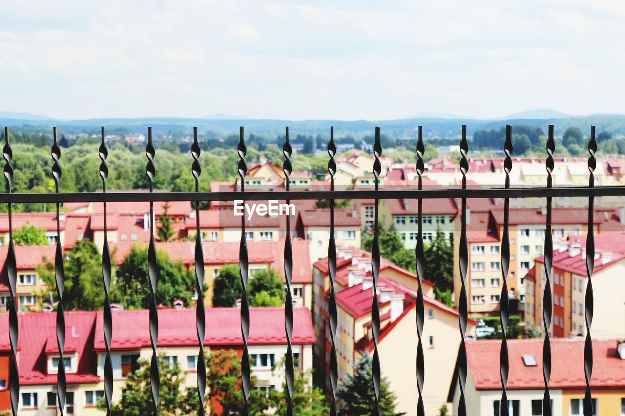 PANORAMIC SHOT OF PLANTS BY BUILDING AGAINST SKY