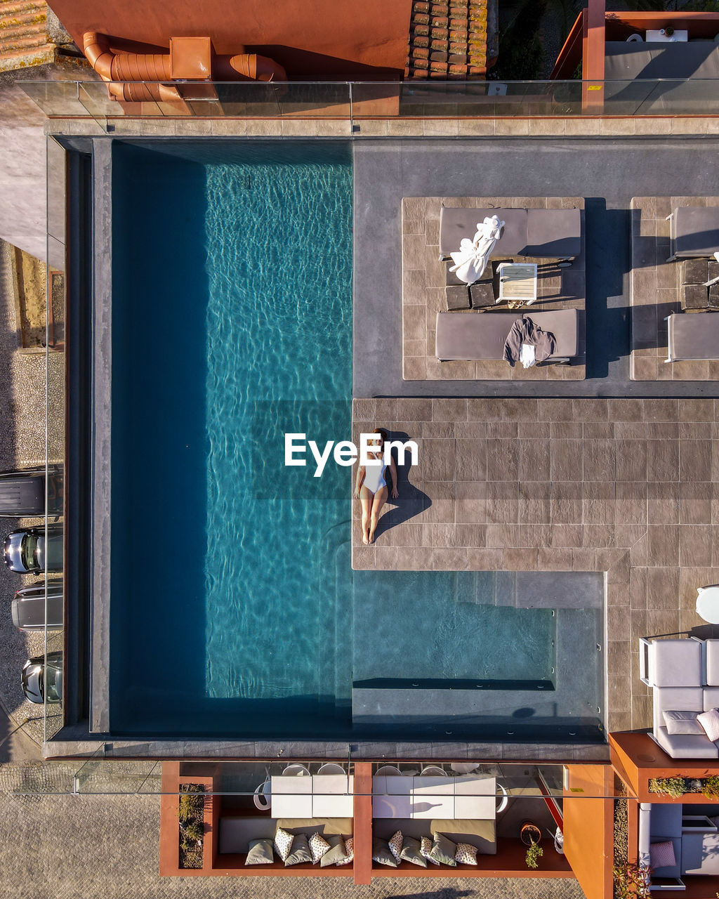 Reflection of woman next to a swimming pool 