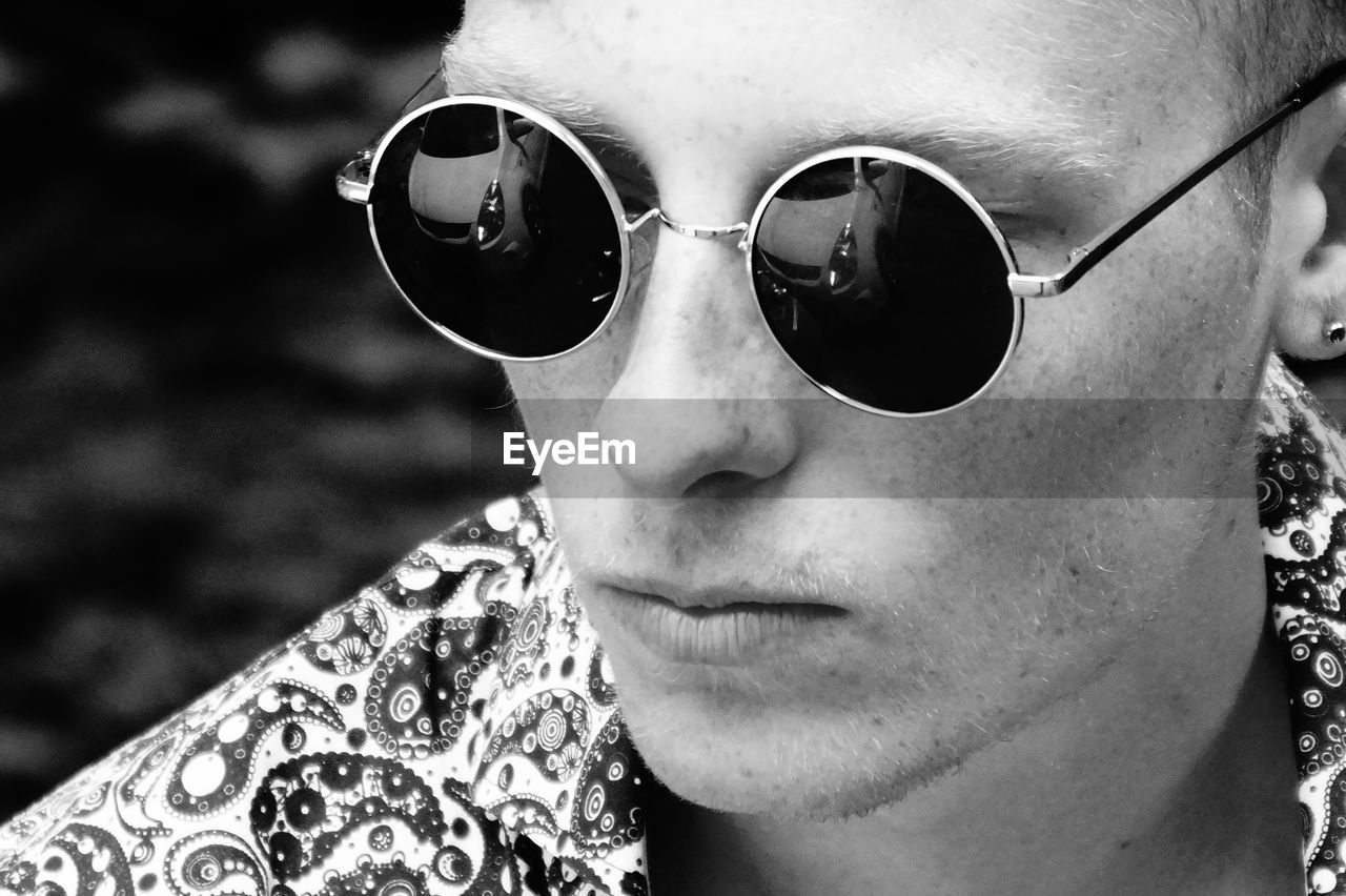 Close-up portrait of young man wearing sunglasses