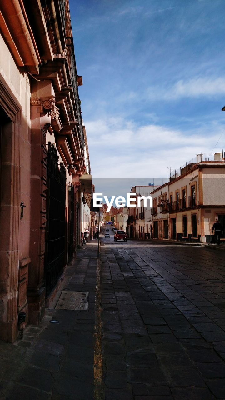 COBBLESTONE STREET AMIDST BUILDINGS