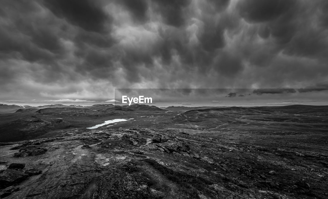 Scenic view of storm clouds over landscape