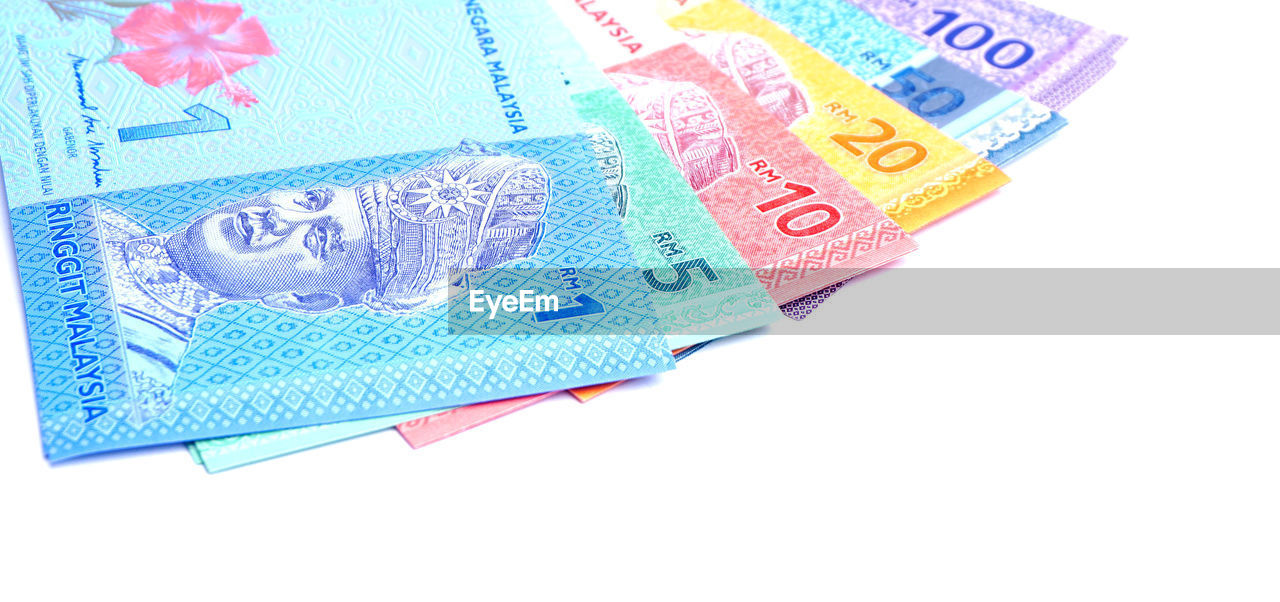 Close-up of paper currency over white background