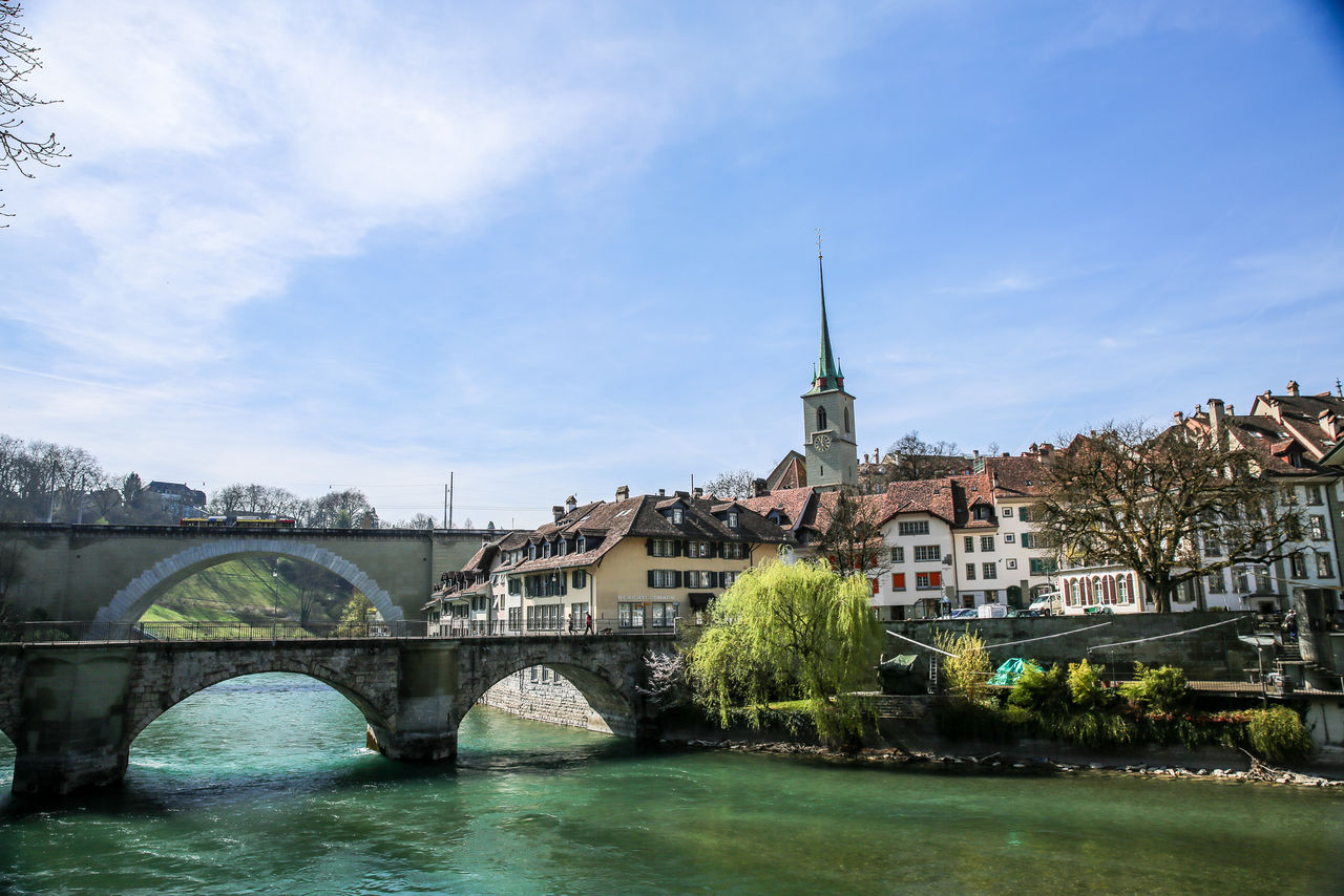 Bridge over river with buildings in background