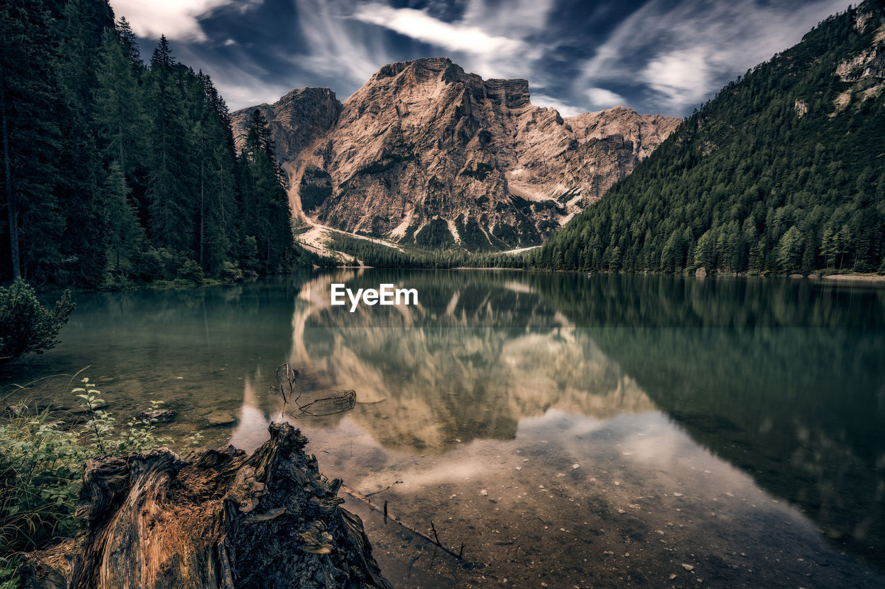 Scenic view of lake by mountains against sky