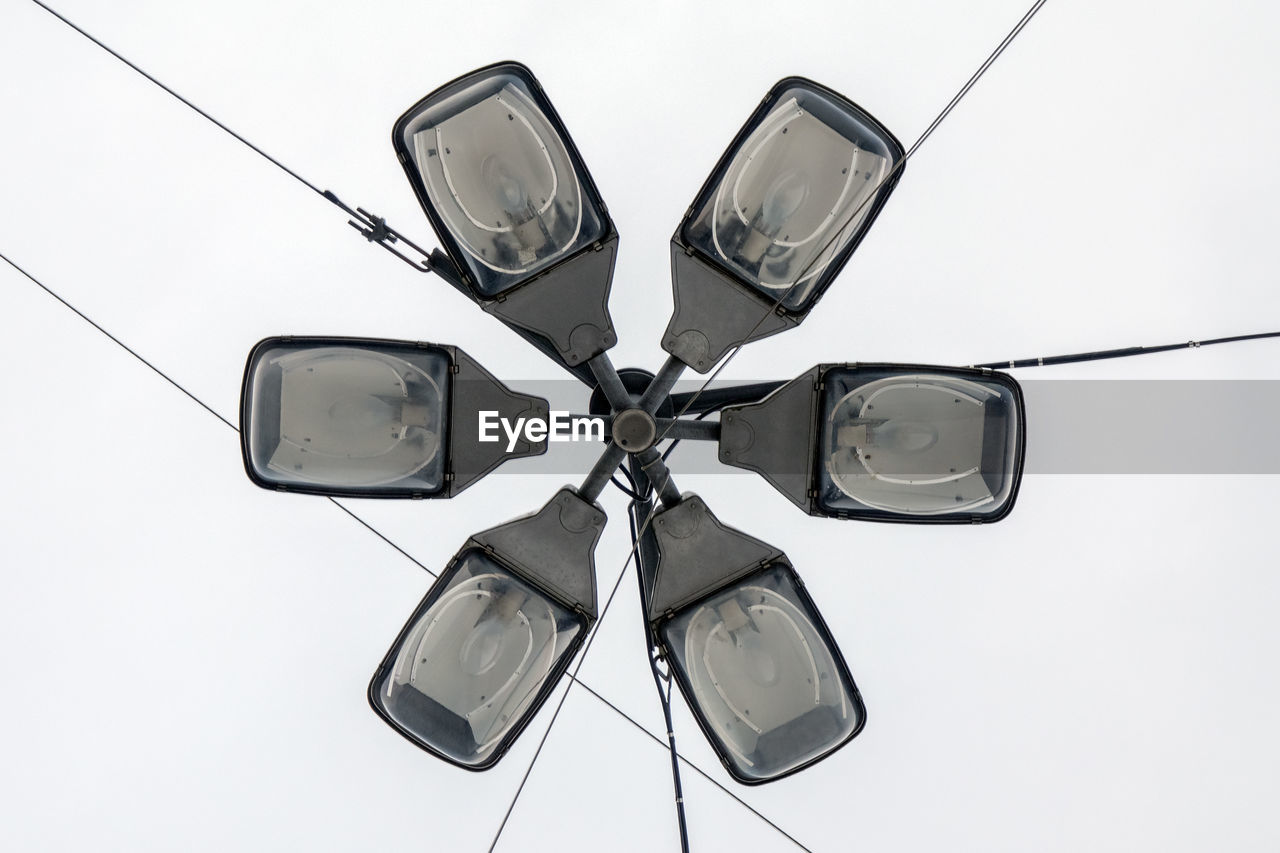 Low angle view of electric lamp against white background