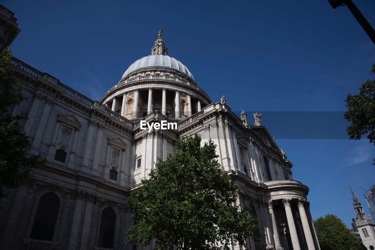 Low angle view of st pauls cathedral against clear sky in city