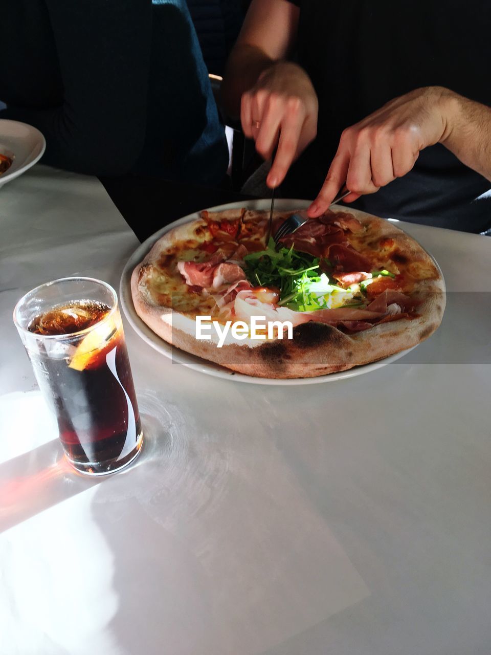 CLOSE-UP OF MAN PREPARING FOOD IN PLATE