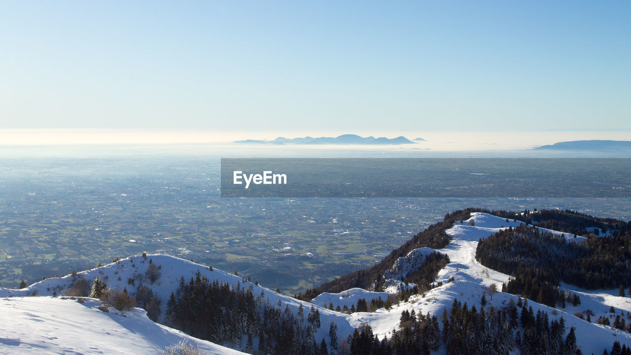 SCENIC VIEW OF SNOWCAPPED MOUNTAINS AGAINST SKY DURING WINTER