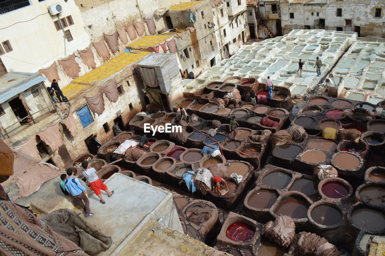 High angle view of people working at traditional dyeing pits