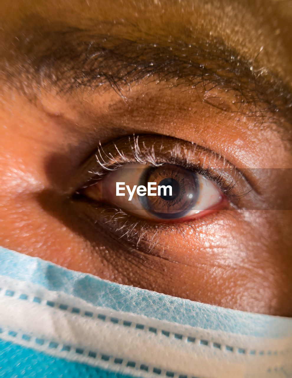 Close up of african american man dark brown eyes for use in ophthalmology optometry imagery