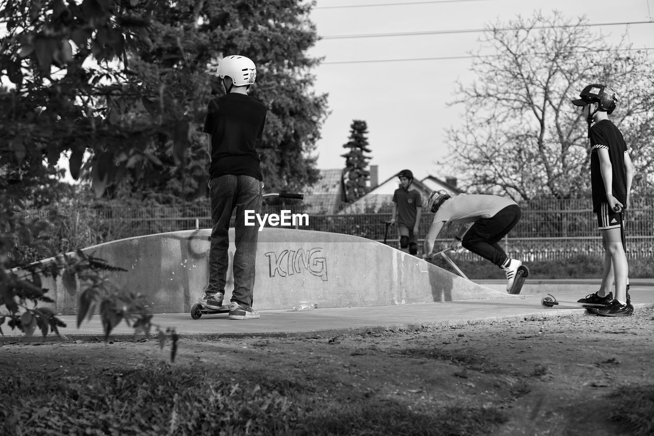 black and white, sports equipment, monochrome, black, tree, skateboard, men, plant, full length, skateboarding, leisure activity, monochrome photography, day, lifestyles, nature, sports, white, skateboarding equipment, group of people, skill, adult, boardsport, child, skateboard park, footwear, motion, outdoors, recreation, casual clothing, person, childhood, women, sky, balance, standing