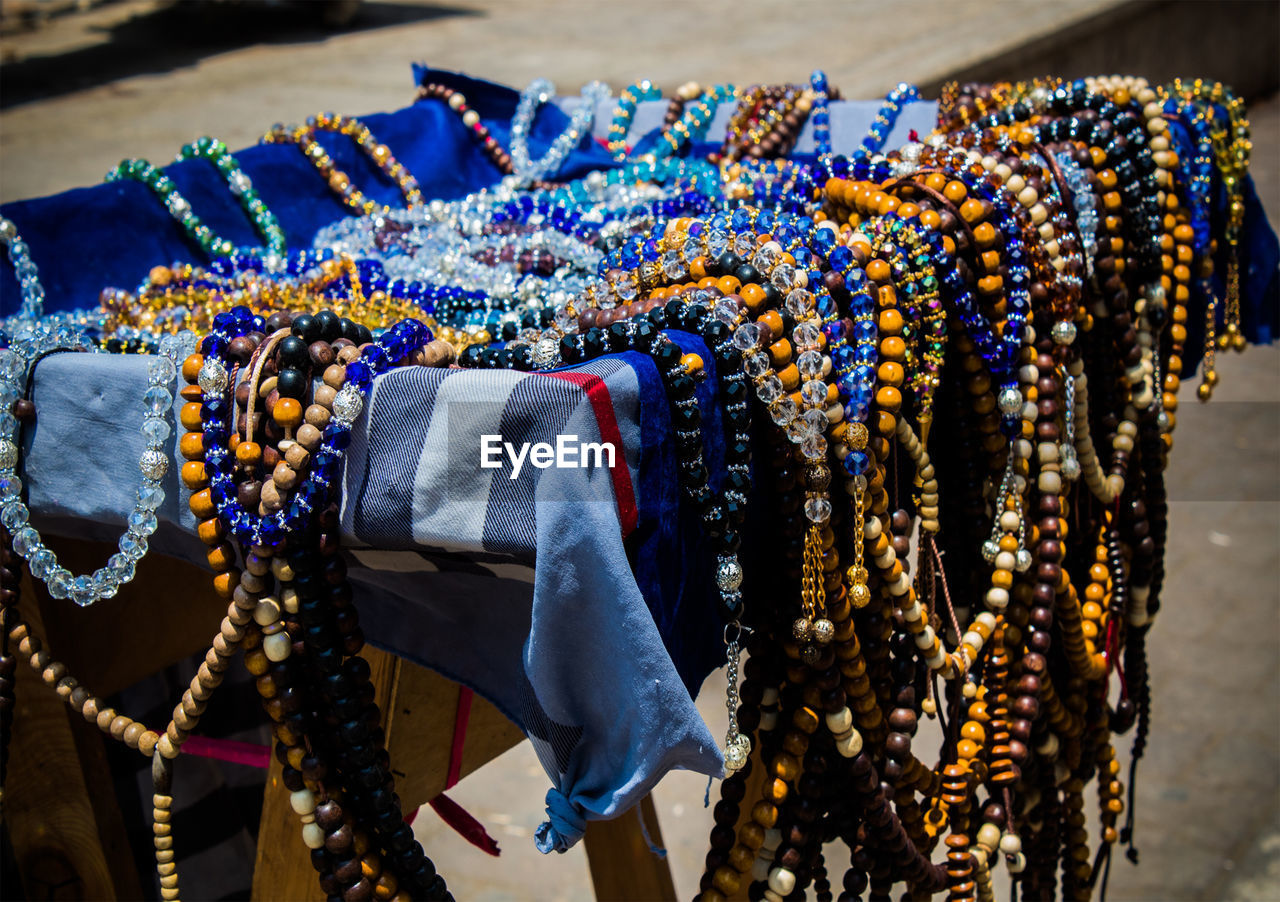 Close-up of multi colored jewelry hanging at store