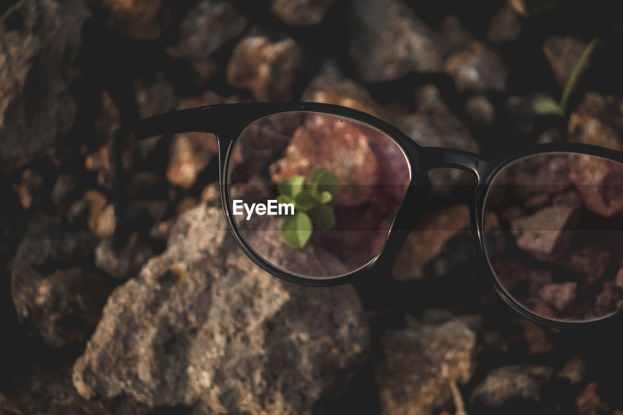 Close-up of sunglasses on rock