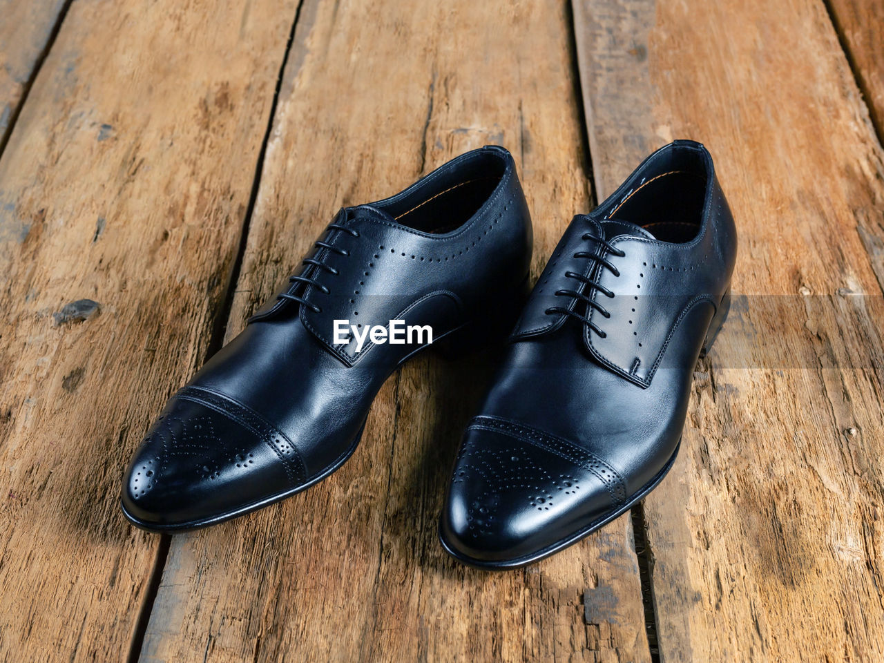 HIGH ANGLE VIEW OF SHOES ON HARDWOOD FLOOR