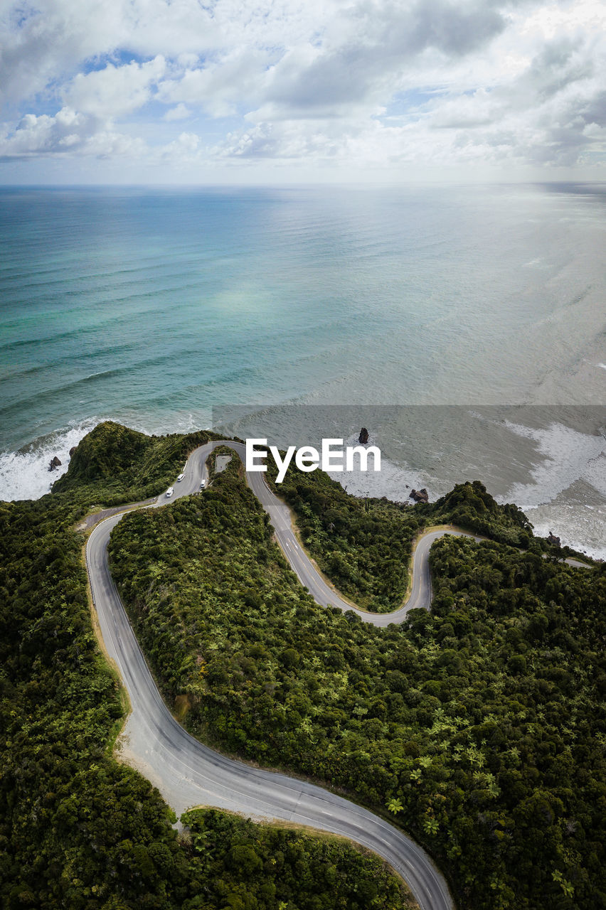 High angle view of road by sea against sky