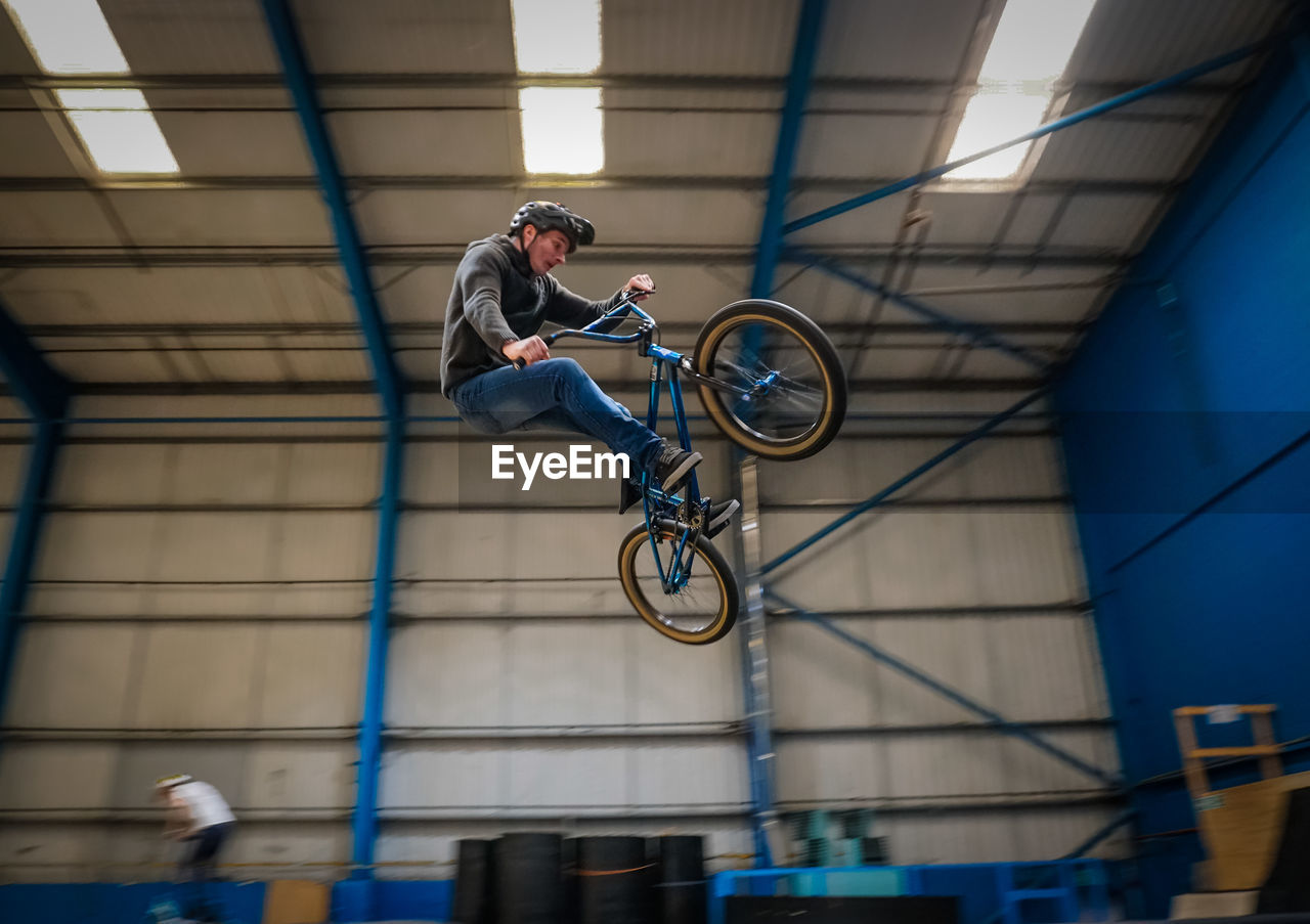 Man jumping while riding bicycle