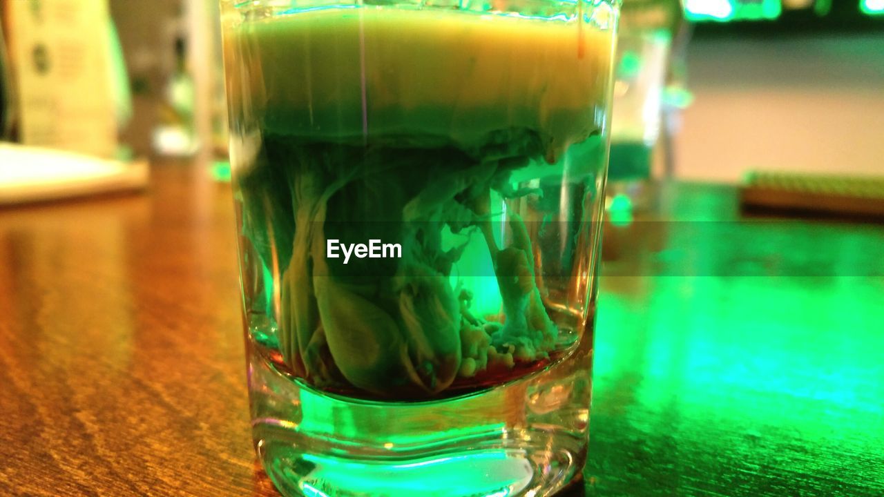 CLOSE-UP OF BEER IN GLASS ON TABLE