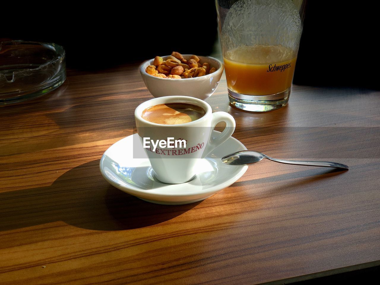 COFFEE CUP ON TABLE AGAINST GLASS