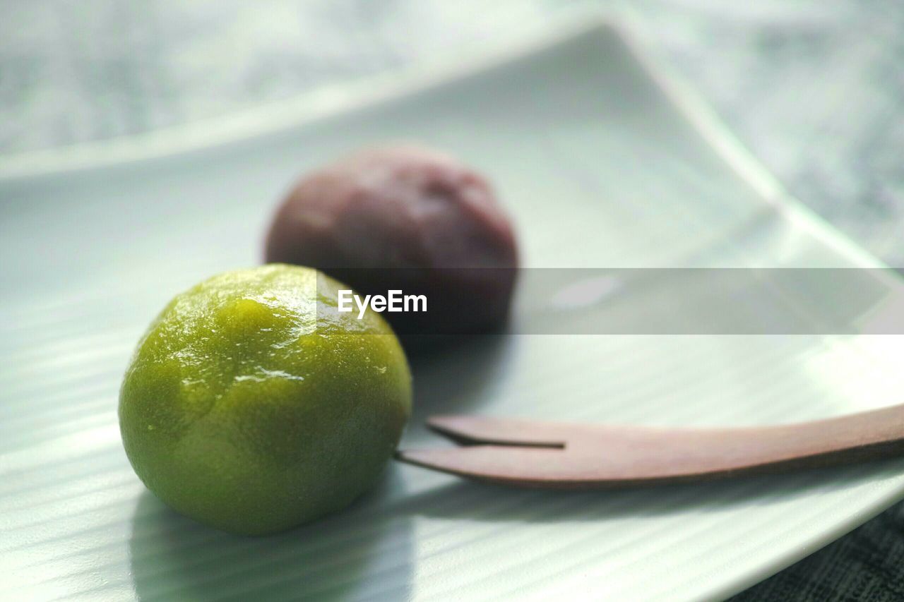 Close-up of desserts by spoon served in plate