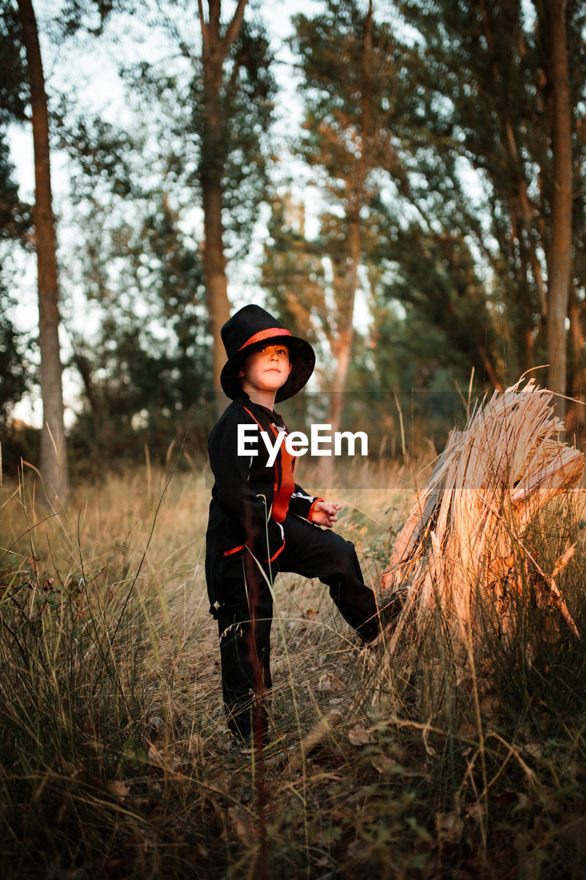 Portrait of boy wearing costume during halloween standing at forest