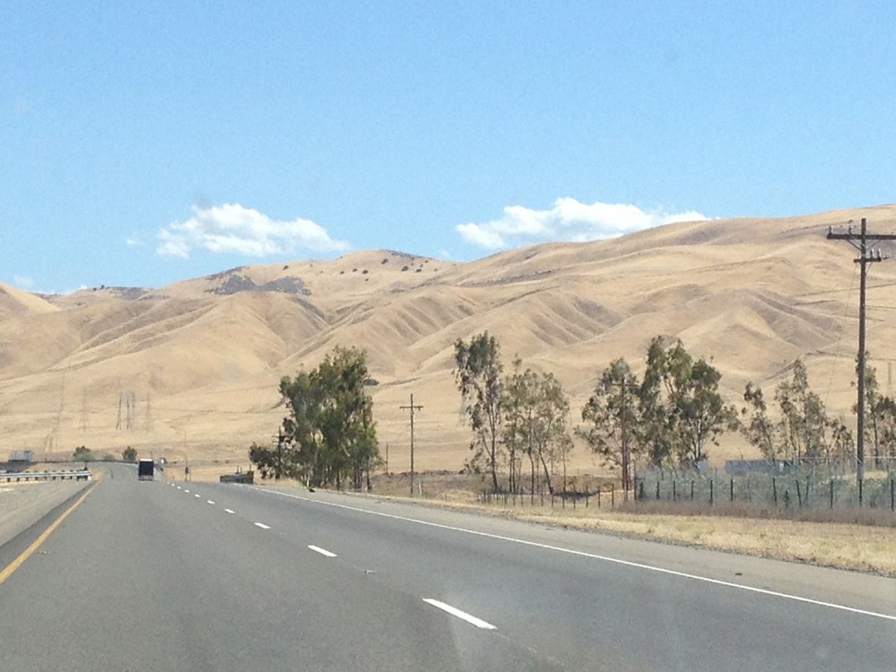 Empty country road along barren mountain range