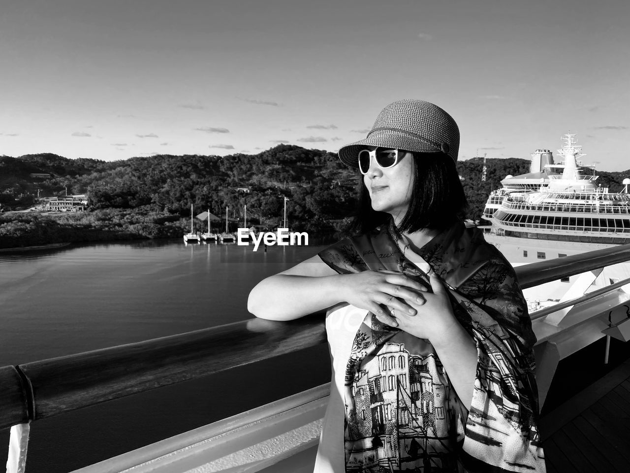 Smiling woman standing at boat deck