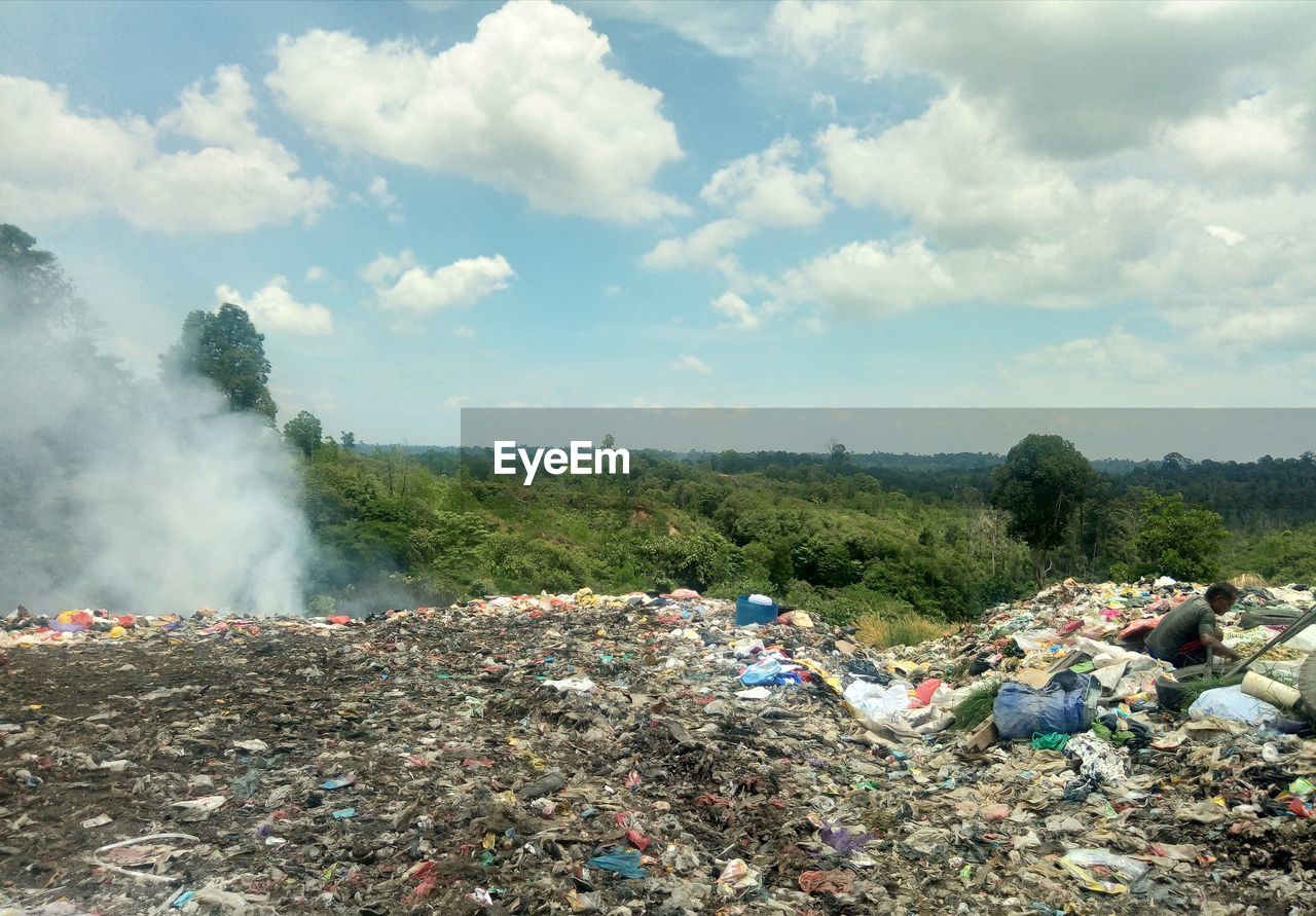 Garbage on land against sky