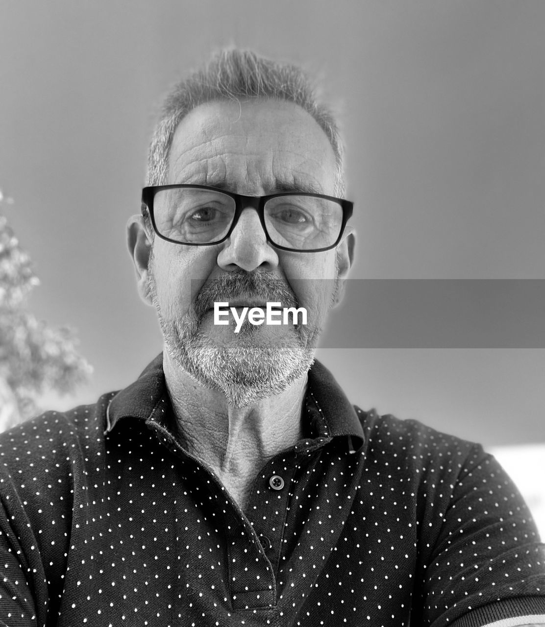 eyeglasses, glasses, portrait, adult, one person, senior adult, black and white, headshot, men, facial hair, beard, person, front view, looking at camera, mature adult, gray hair, monochrome photography, monochrome, seniors, casual clothing, indoors, emotion, vision care, smiling, lifestyles, moustache, portrait photography, happiness, human face, eyewear, studio shot, close-up, facial expression, contemplation, looking