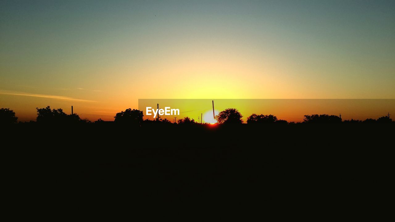 SCENIC VIEW OF SILHOUETTE LANDSCAPE AGAINST ORANGE SKY