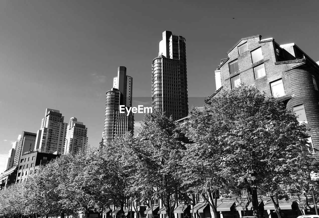 Low angle view of modern buildings against clear sky