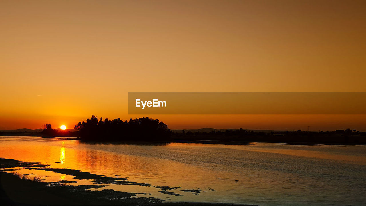 View of calm sea at sunset