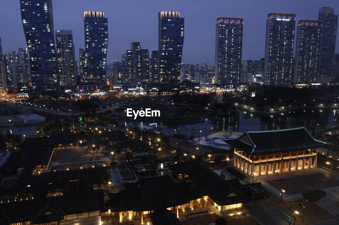 High angle view of illuminated buildings in city at night