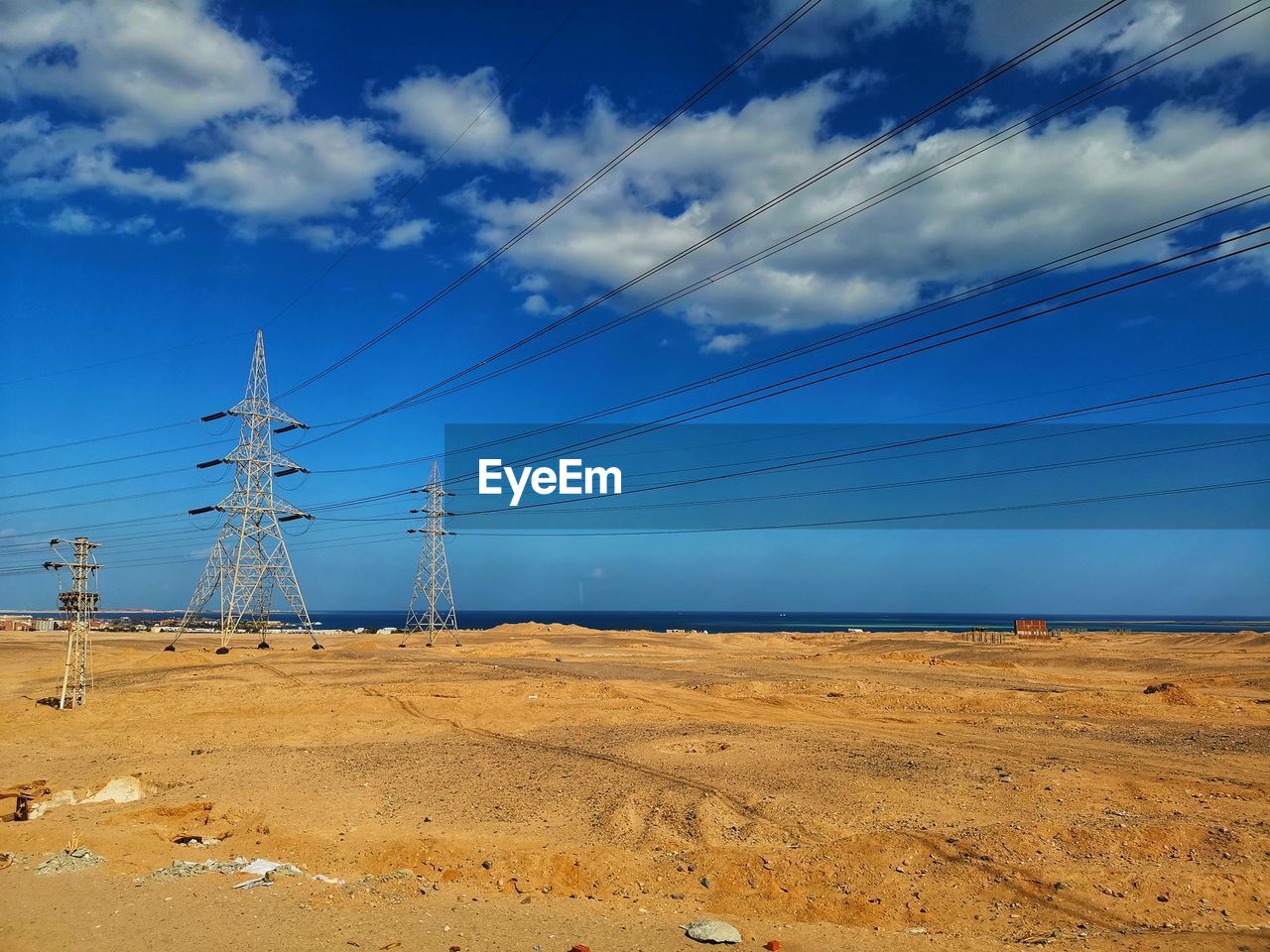 ELECTRICITY PYLON ON LAND AGAINST SKY