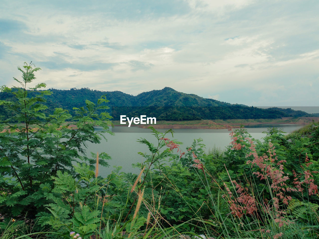 SCENIC VIEW OF LAKE BY MOUNTAIN AGAINST SKY