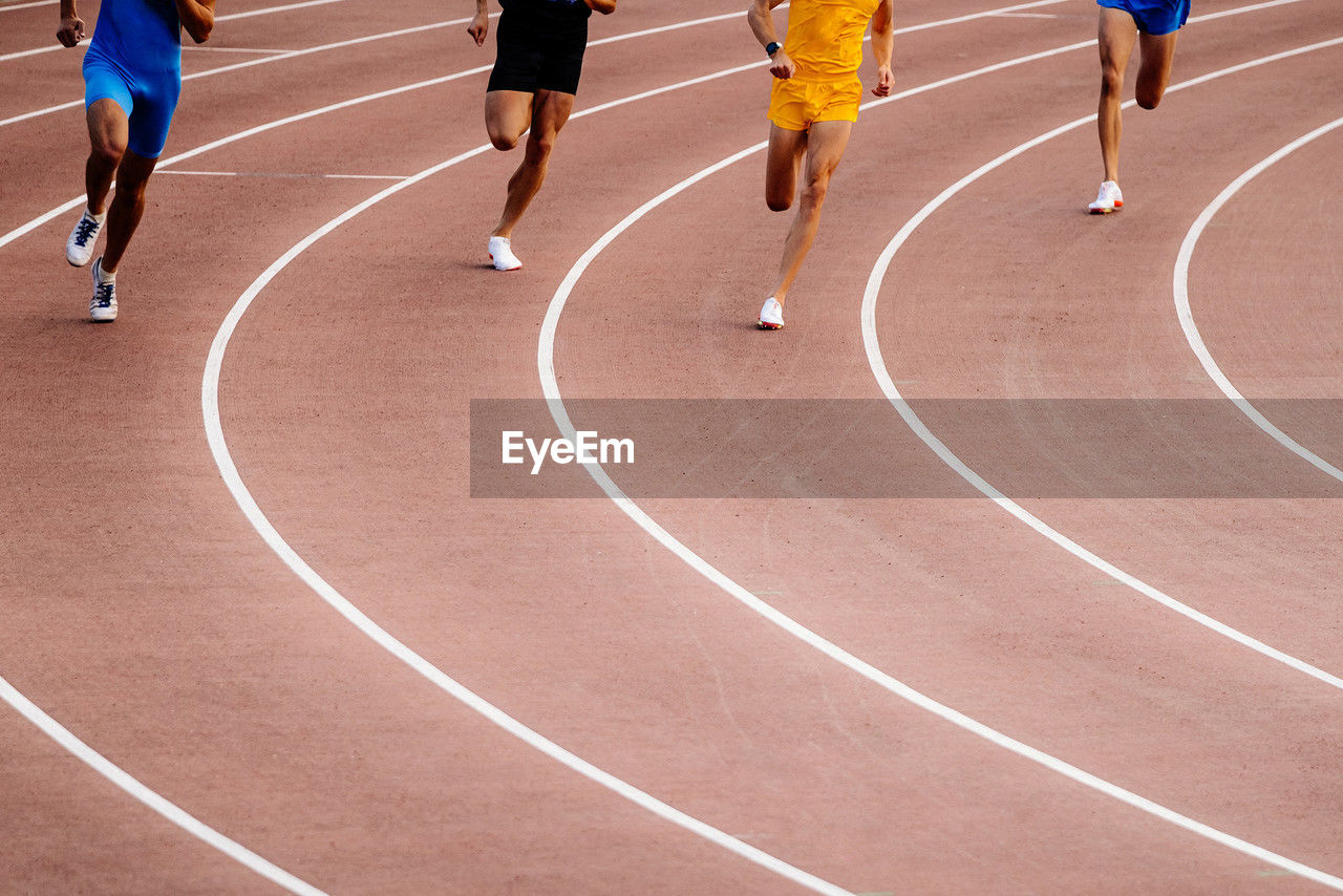 low section of people walking on playing field