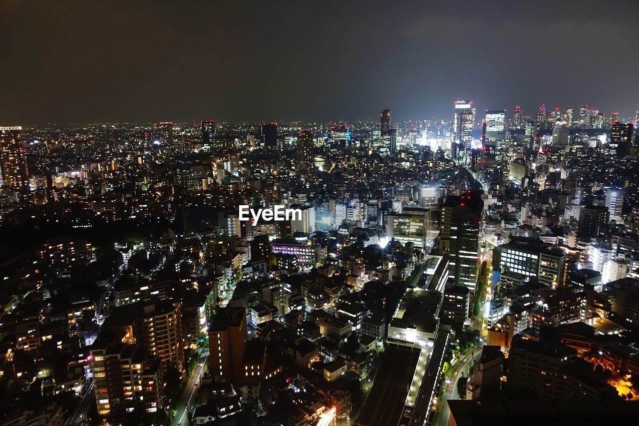 High angle view of illuminated city buildings at night