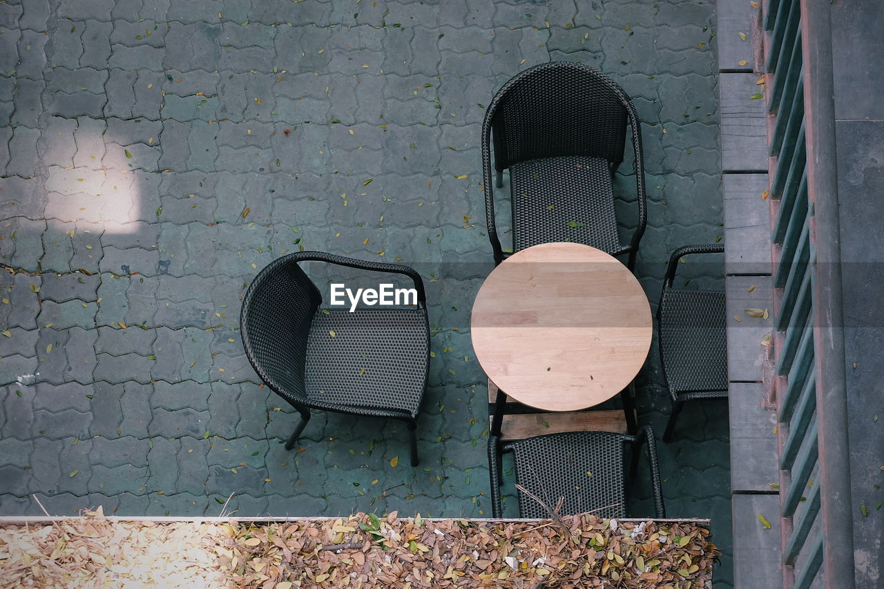 High angle view of table with chairs at sidewalk cafe