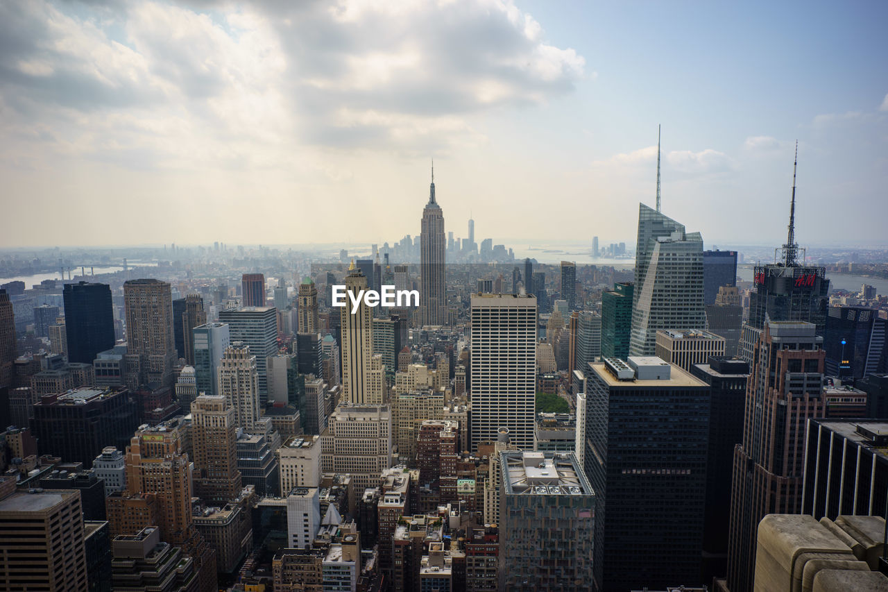 View of skyscrapers against cloudy sky