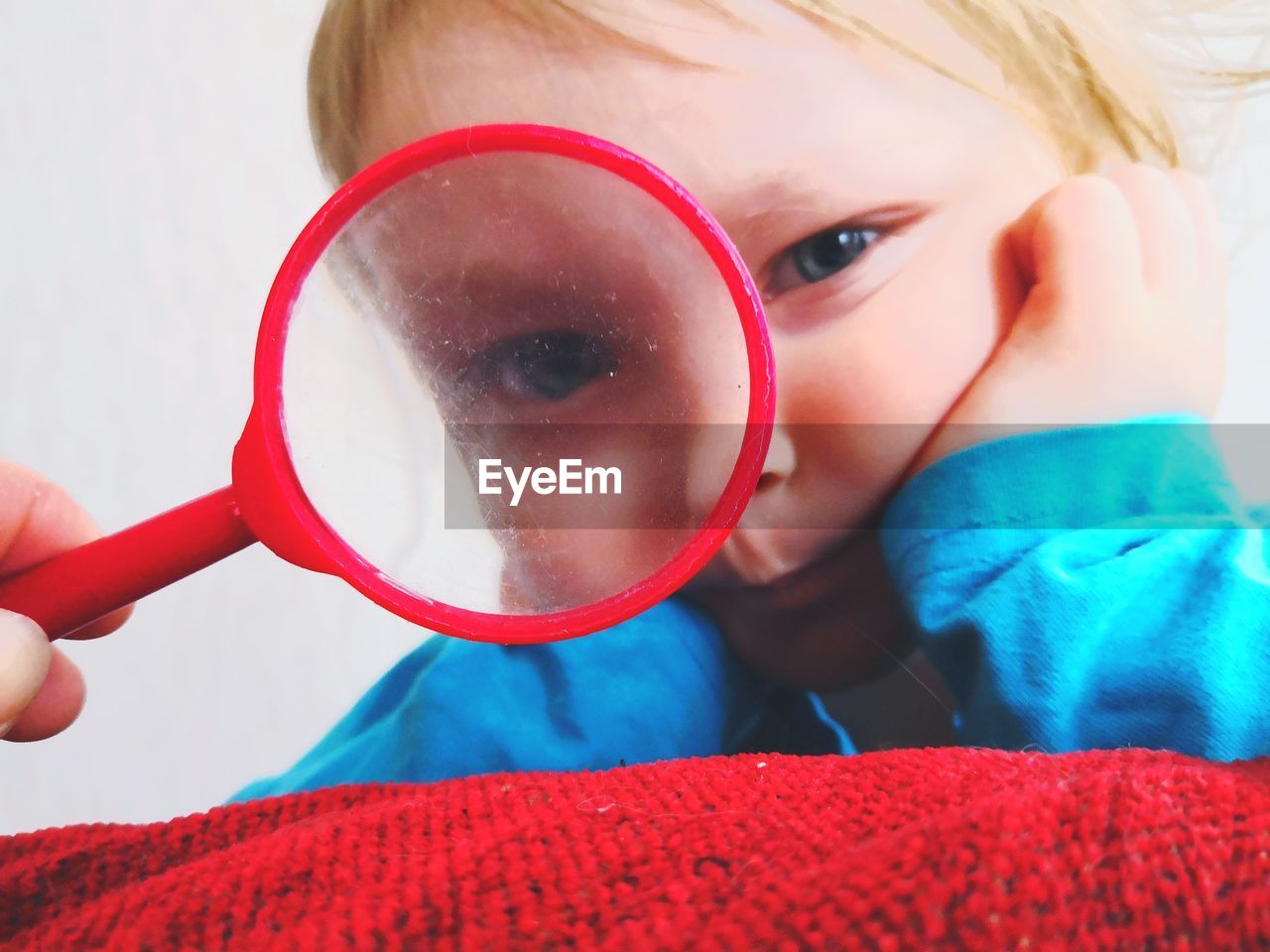 Portrait of boy holding magnifying glass