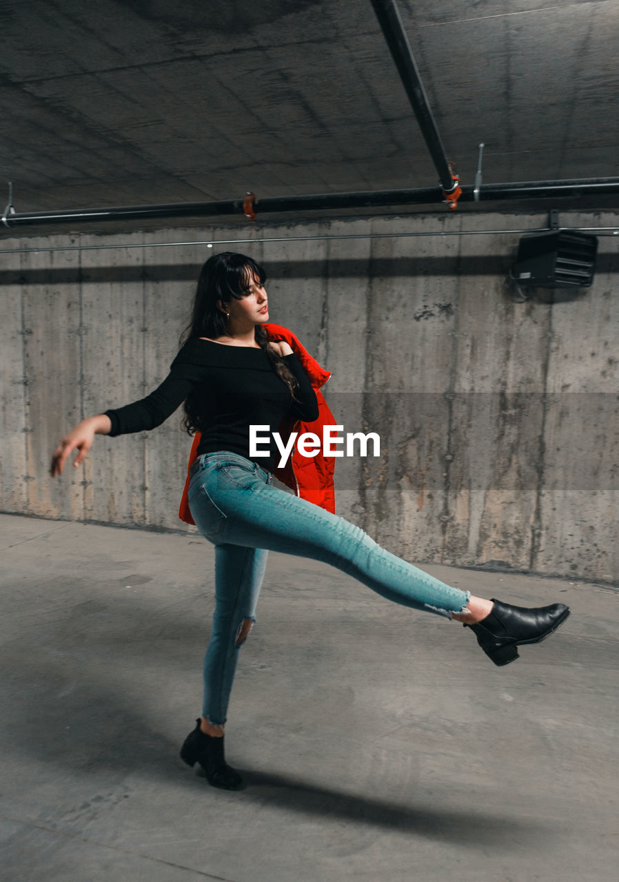 Young woman dancing in garage