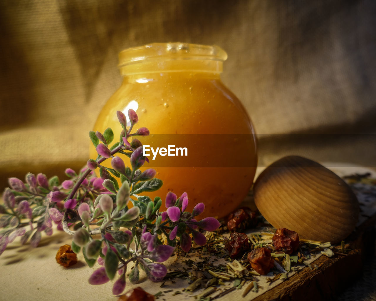 CLOSE-UP OF GLASS OF JAR ON TABLE