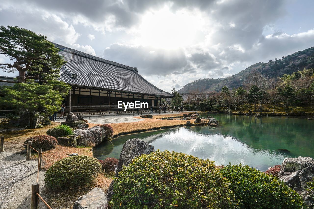 Scenic view of lake by building against sky