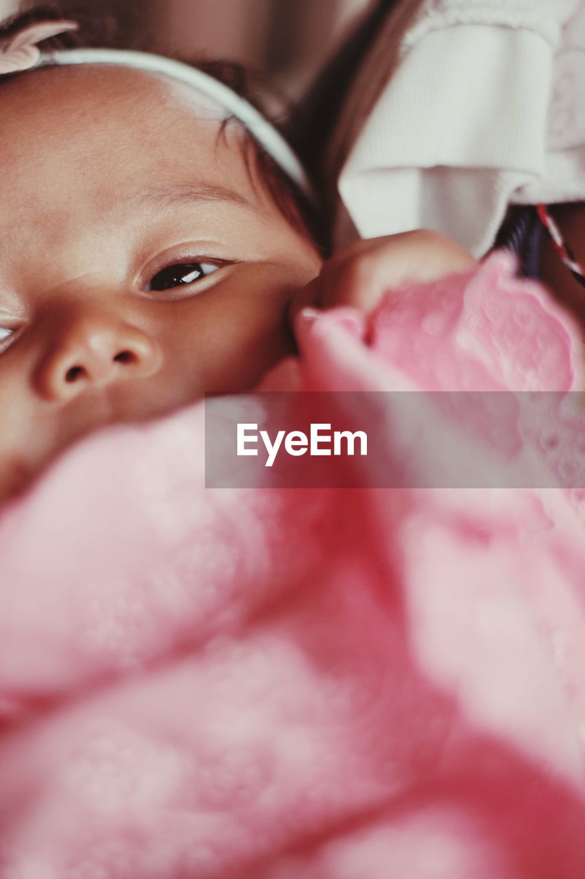 pink, child, skin, childhood, close-up, baby, portrait, sweetness, person, one person, innocence, indoors, selective focus, cute, human face, beginnings, lying down, emotion, headshot, female, women, relaxation, toddler, babyhood, looking at camera, looking, portrait photography, newborn, lifestyles, adult, human mouth