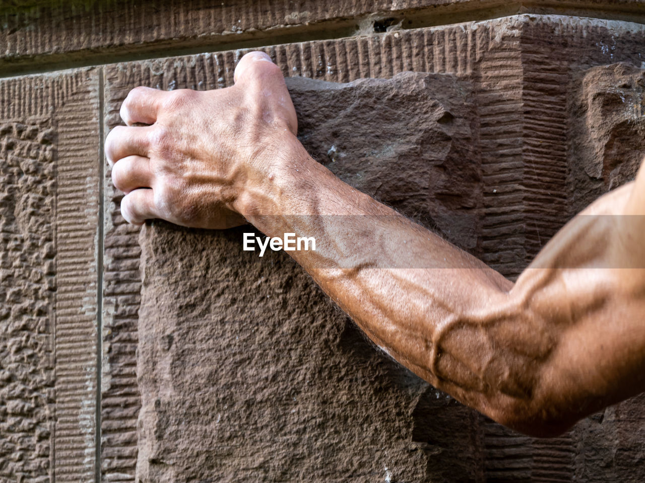 low section of man standing on wall